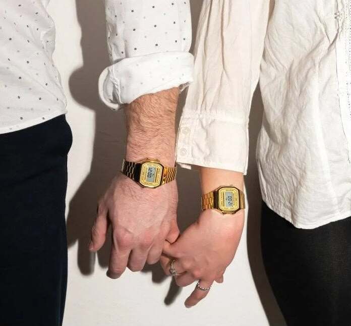Casio gold-tone A168 worn by a man and a woman wearing professional white shirts and black trousers.